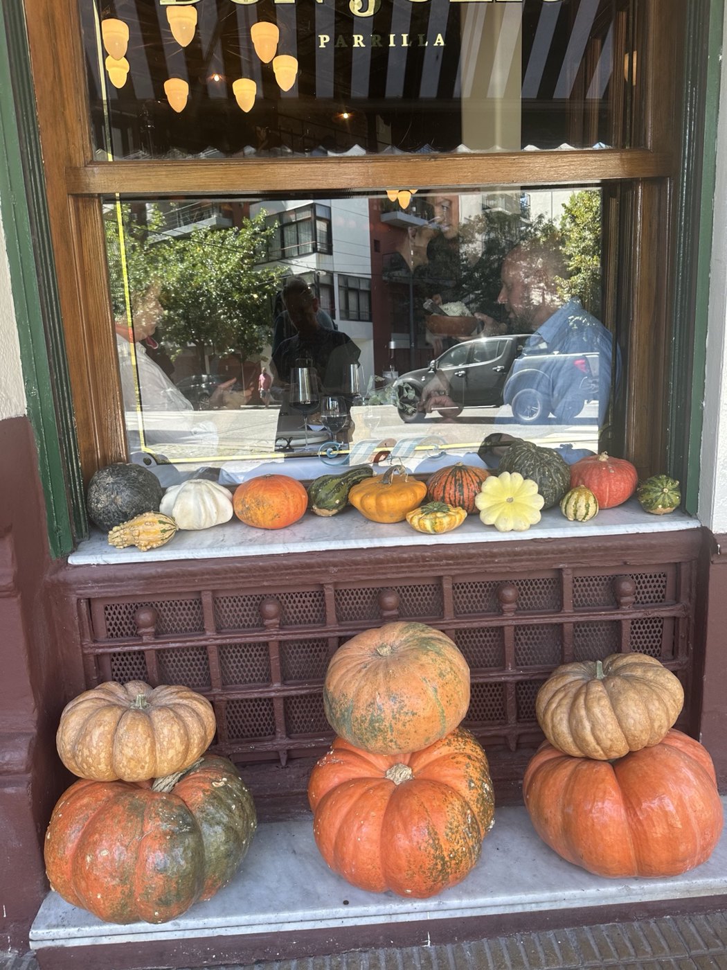An autumn-like display of pumpkins and colorful gourds along the window of Don Julio in Buenos Aires.