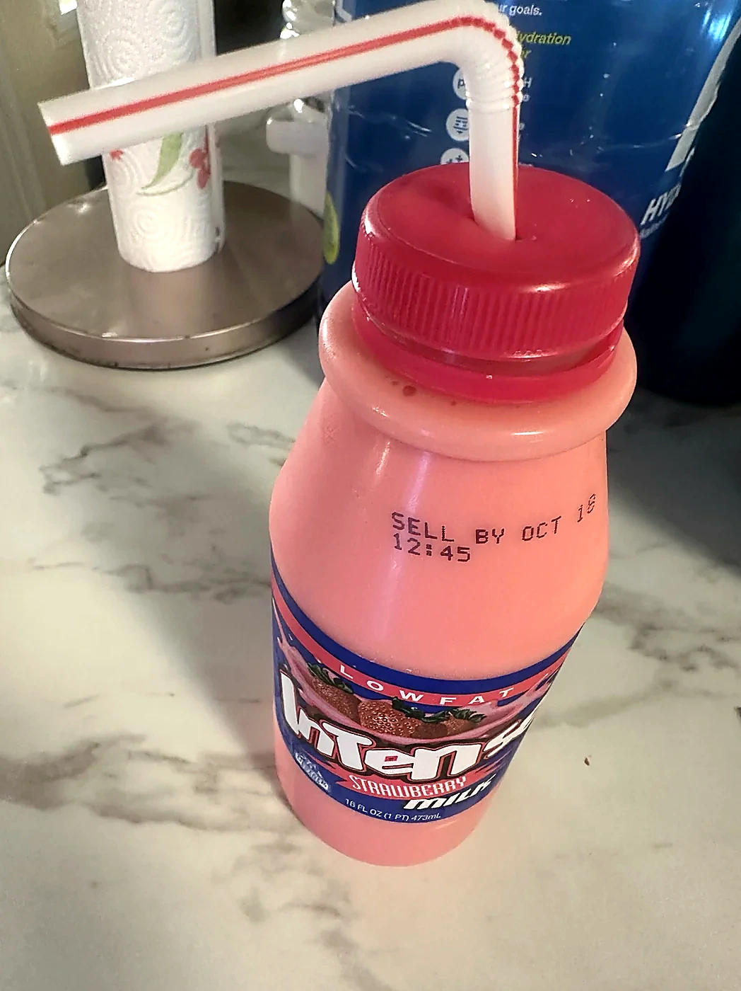 Our photographed strawberry-milk and straw experiment; not a recommended daily lid setup.