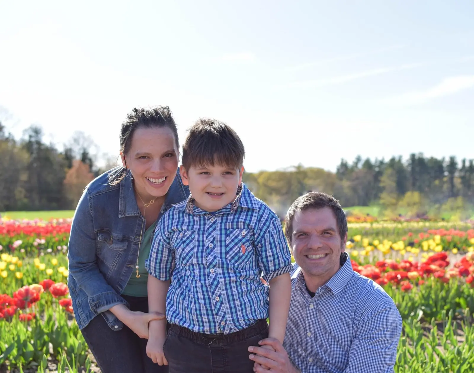Our family together among rows of colorful flowers at Wicked Tulips.