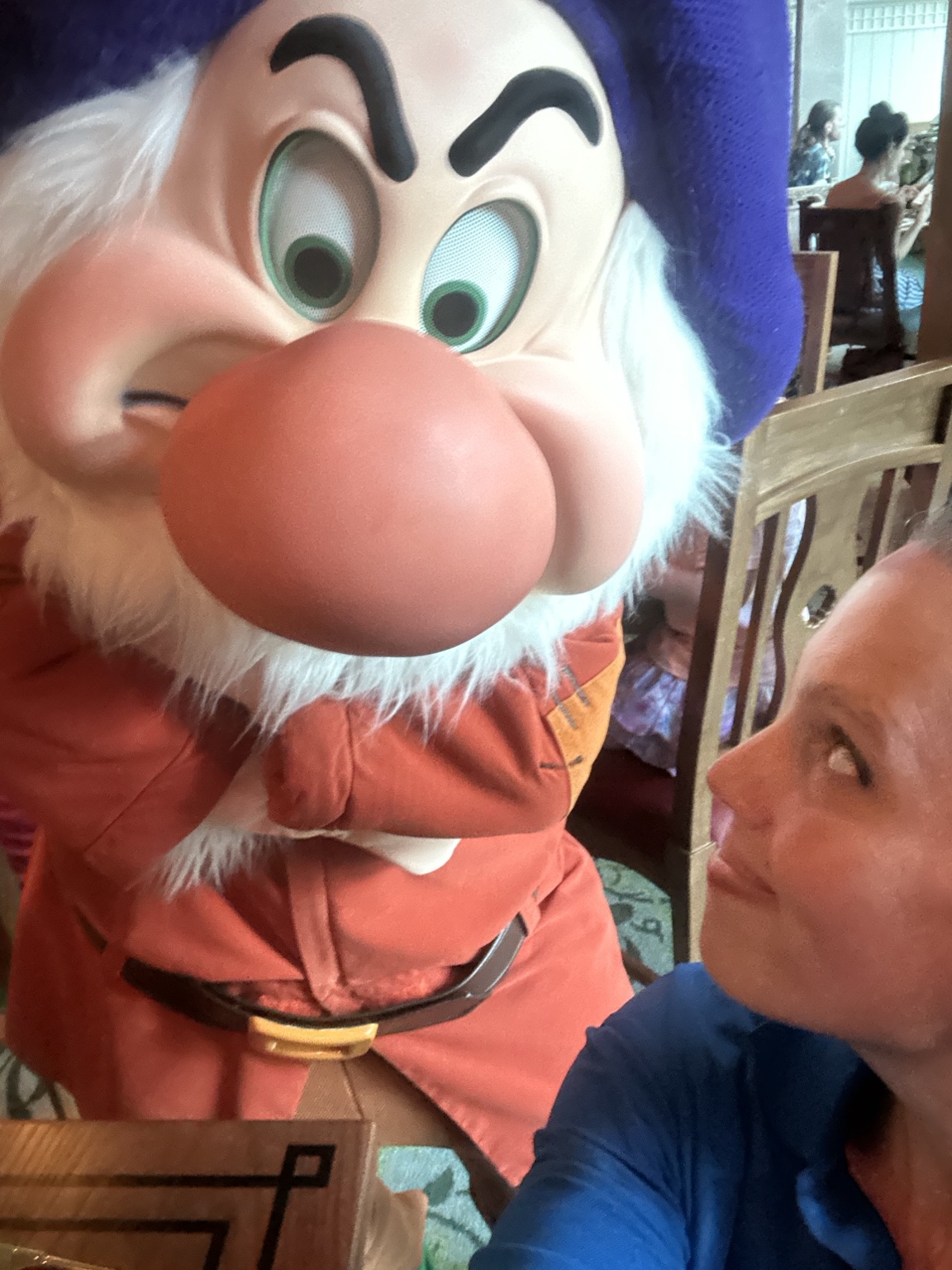 Hannah posing beside a dwarf character during the trip.