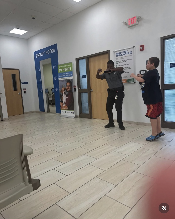 The guard holds his arms in front of him while James extends his own arms as they dance.
