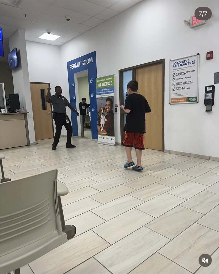 James stands facing the dancing guard, who has one arm raised and his knees bent.